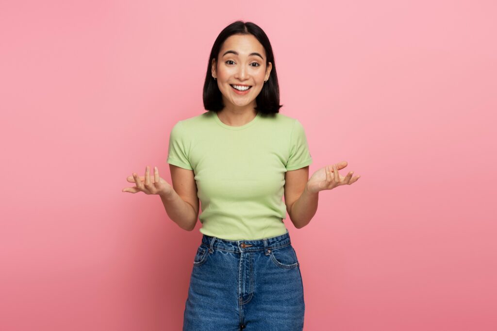 Uncertain positive woman with raised arms, dont know what to do